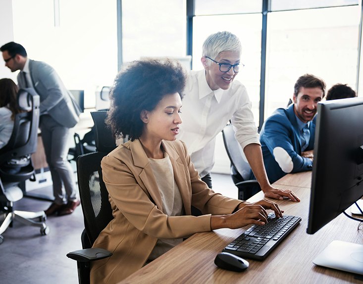 Women at a computer in an office setting